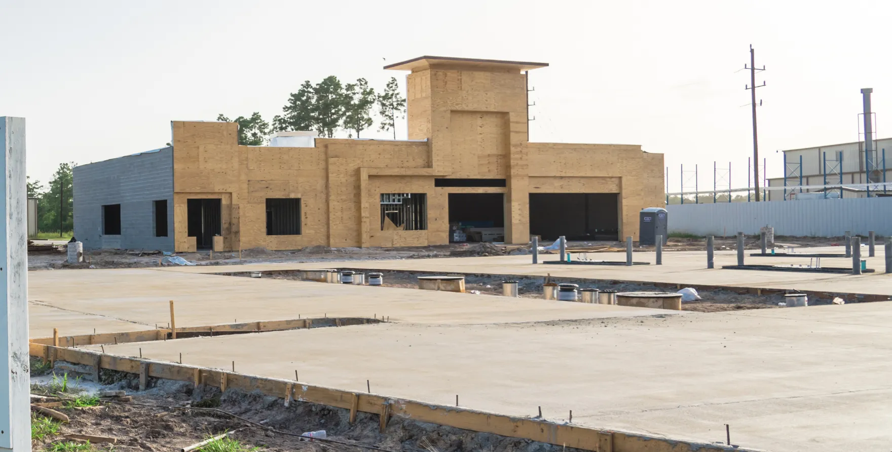 Commercial building slab foundation with formwork and utility lines prepared for concrete placement
